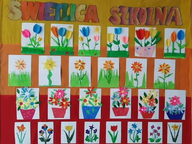 Żółto-pomarańczowo-czerwone tło, różnokolorowe litery, prace dzieci - różnokolorowe kwiaty wykonane z papieru.